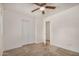 Bedroom features plush carpeting, a ceiling fan and an open door that leads to another room at 5101 E Toniko Dr, Phoenix, AZ 85044