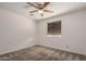 Bedroom with neutral carpet, a ceiling fan, and a window with blinds for natural light at 5101 E Toniko Dr, Phoenix, AZ 85044