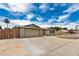 Home showcasing a two-car garage, brickwork facade, and landscaped front yard at 5101 E Toniko Dr, Phoenix, AZ 85044
