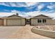 Charming single-story home featuring a stone walkway and a spacious two-car garage at 5101 E Toniko Dr, Phoenix, AZ 85044