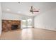 Spacious living room features a brick fireplace and sliding glass doors to the backyard at 5101 E Toniko Dr, Phoenix, AZ 85044