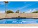 Sparkling blue private pool with waterfall feature and desert landscaping at 5101 E Toniko Dr, Phoenix, AZ 85044