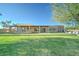 Expansive backyard with lush greenery and a covered patio is perfect for entertaining at 6519 E Cactus Rd, Scottsdale, AZ 85254
