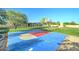 Basketball court features a vibrant blue and red paint scheme in a spacious backyard at 6519 E Cactus Rd, Scottsdale, AZ 85254