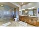Bright bathroom featuring a large glass shower, double sinks, and granite countertops at 6519 E Cactus Rd, Scottsdale, AZ 85254