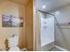 Neutral bathroom featuring a combined shower and bathtub with a convenient shelf at 6519 E Cactus Rd, Scottsdale, AZ 85254