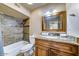 Bathroom featuring a tub shower, granite countertops, vanity, and tile backsplash at 6519 E Cactus Rd, Scottsdale, AZ 85254