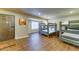 Bedroom with wood-look floors, bunk beds, and a front door at 6519 E Cactus Rd, Scottsdale, AZ 85254