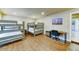 Spacious bedroom features hardwood floors and two bunk beds with matching end tables and a desk at 6519 E Cactus Rd, Scottsdale, AZ 85254