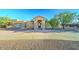 Stunning single-story home with a grand entrance, mature trees, and a circular driveway at 6519 E Cactus Rd, Scottsdale, AZ 85254