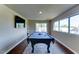 Spacious game room with a pool table, recessed lighting, and large windows overlooking the exterior at 6519 E Cactus Rd, Scottsdale, AZ 85254
