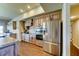 Traditional kitchen featuring stainless steel appliances, wooden cabinetry, and hardwood flooring at 6519 E Cactus Rd, Scottsdale, AZ 85254