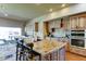 Well-appointed kitchen offers a large island, granite counters, stainless steel appliances, and custom cabinetry at 6519 E Cactus Rd, Scottsdale, AZ 85254