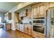 Traditional kitchen featuring stainless steel appliances, wooden cabinetry, and hardwood flooring at 6519 E Cactus Rd, Scottsdale, AZ 85254
