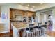 Spacious kitchen features a granite island, breakfast bar, wood cabinets, and stainless steel appliances at 6519 E Cactus Rd, Scottsdale, AZ 85254