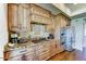 Gourmet kitchen with wooden cabinets, granite countertops, stainless steel appliances, and stylish finishes at 6519 E Cactus Rd, Scottsdale, AZ 85254