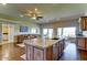 Bright kitchen with a large island, stainless steel sink, hardwood floors, and an open layout at 6519 E Cactus Rd, Scottsdale, AZ 85254