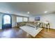 Bright living room with hardwood floors, shuttered windows, large sectional, and decor at 6519 E Cactus Rd, Scottsdale, AZ 85254