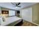 Main bedroom with a fan, closet, carpet flooring, window with plantation shutters, and a queen bed at 6519 E Cactus Rd, Scottsdale, AZ 85254