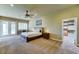 Bright main bedroom featuring a ceiling fan, walk-in closet, carpet, and patio access at 6519 E Cactus Rd, Scottsdale, AZ 85254