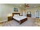 Comfortable main bedroom featuring a ceiling fan, carpet, dresser, and nightstands at 6519 E Cactus Rd, Scottsdale, AZ 85254