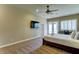 Comfortable main bedroom featuring a ceiling fan, carpet, shutters, and exterior access at 6519 E Cactus Rd, Scottsdale, AZ 85254