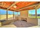 Covered patio features a brick fireplace, tile flooring, and views of the backyard at 6519 E Cactus Rd, Scottsdale, AZ 85254