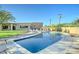 Inviting pool area with lush landscaping and a clear blue sky at 6519 E Cactus Rd, Scottsdale, AZ 85254