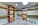 Walk-in closet featuring custom wood shelving and drawers for optimal storage at 6519 E Cactus Rd, Scottsdale, AZ 85254