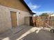Backyard features a secure wooden gate, providing access to yard from exterior door at 664 N Glenview --, Mesa, AZ 85213