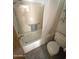 Traditional bathroom with a shower-tub combo, tile walls, and functional fixtures at 664 N Glenview --, Mesa, AZ 85213