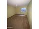Bedroom featuring yellow walls, tan carpet, ceiling fan, and natural light from small window at 664 N Glenview --, Mesa, AZ 85213
