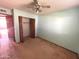 Bedroom featuring light green walls, carpet flooring, and a closet with doors open at 664 N Glenview --, Mesa, AZ 85213