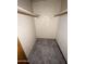 Walk-in closet with tile walls, flooring, wood shelves, and a rod for hanging clothes at 664 N Glenview --, Mesa, AZ 85213