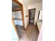 Hallway leading to the bathroom and a walk-in closet with wood trim at 664 N Glenview --, Mesa, AZ 85213