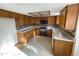 Traditional kitchen with wooden cabinets, neutral countertops, and black appliances at 664 N Glenview --, Mesa, AZ 85213