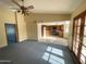 Open living space with doors to the patio, a ceiling fan, and easy access to the kitchen at 664 N Glenview --, Mesa, AZ 85213