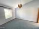 Cozy living room with a window, carpet floors, and chandelier at 664 N Glenview --, Mesa, AZ 85213