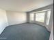 Bright living room featuring a large bay window, neutral paint, and plush carpeting at 664 N Glenview --, Mesa, AZ 85213
