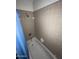 Tile-walled shower with curtain, faucet, and shower head at 664 N Glenview --, Mesa, AZ 85213