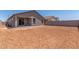 View of a dirt backyard with an enclosed patio and block fence at 7229 E Cattle Call St, San Tan Valley, AZ 85143