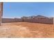 Large dirt backyard space is enclosed by a block wall for privacy at 7229 E Cattle Call St, San Tan Valley, AZ 85143