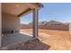 Patio and dirt backyard area enclosed by a block wall at 7229 E Cattle Call St, San Tan Valley, AZ 85143
