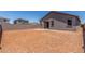 Expansive dirt backyard with a block wall fence and covered patio at 7229 E Cattle Call St, San Tan Valley, AZ 85143