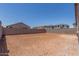 Dirt backyard enclosed by a block wall with multiple neighboring houses at 7229 E Cattle Call St, San Tan Valley, AZ 85143