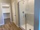 Modern bathroom with a glass-enclosed shower, tile flooring, and a neutral color scheme creating a bright aesthetic at 7229 E Cattle Call St, San Tan Valley, AZ 85143