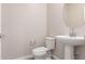 Modern powder room featuring white fixtures and a pedestal sink at 7229 E Cattle Call St, San Tan Valley, AZ 85143
