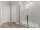 Bathroom with tile floors, white door, and glass enclosed shower at 7229 E Cattle Call St, San Tan Valley, AZ 85143