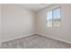 Bright bedroom with neutral carpet and a clear view from the window at 7229 E Cattle Call St, San Tan Valley, AZ 85143