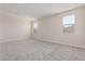 Spacious bedroom with carpet flooring and windows with neighborhood views at 7229 E Cattle Call St, San Tan Valley, AZ 85143